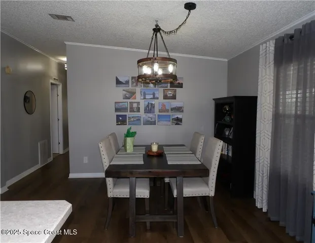 a dining room with a table and chairs