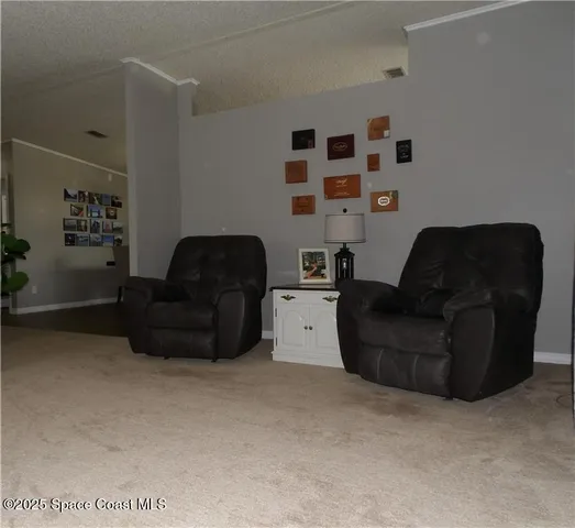 a living room with furniture and a lamp