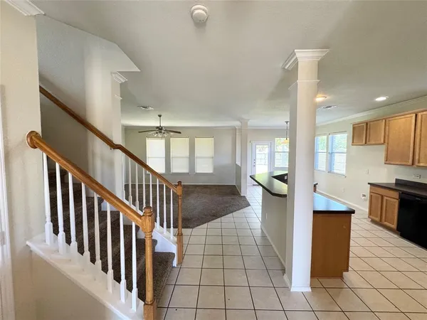an empty room with windows and fireplace