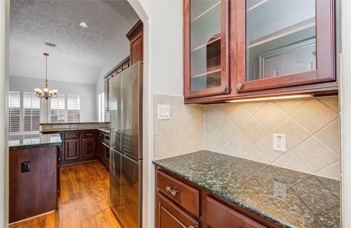 1463 Springrock Lane, Unit A Houston, TX 77055 - Photo 13 of 46 a kitchen with kitchen island a counter top space a sink stainless steel appliances and cabinets