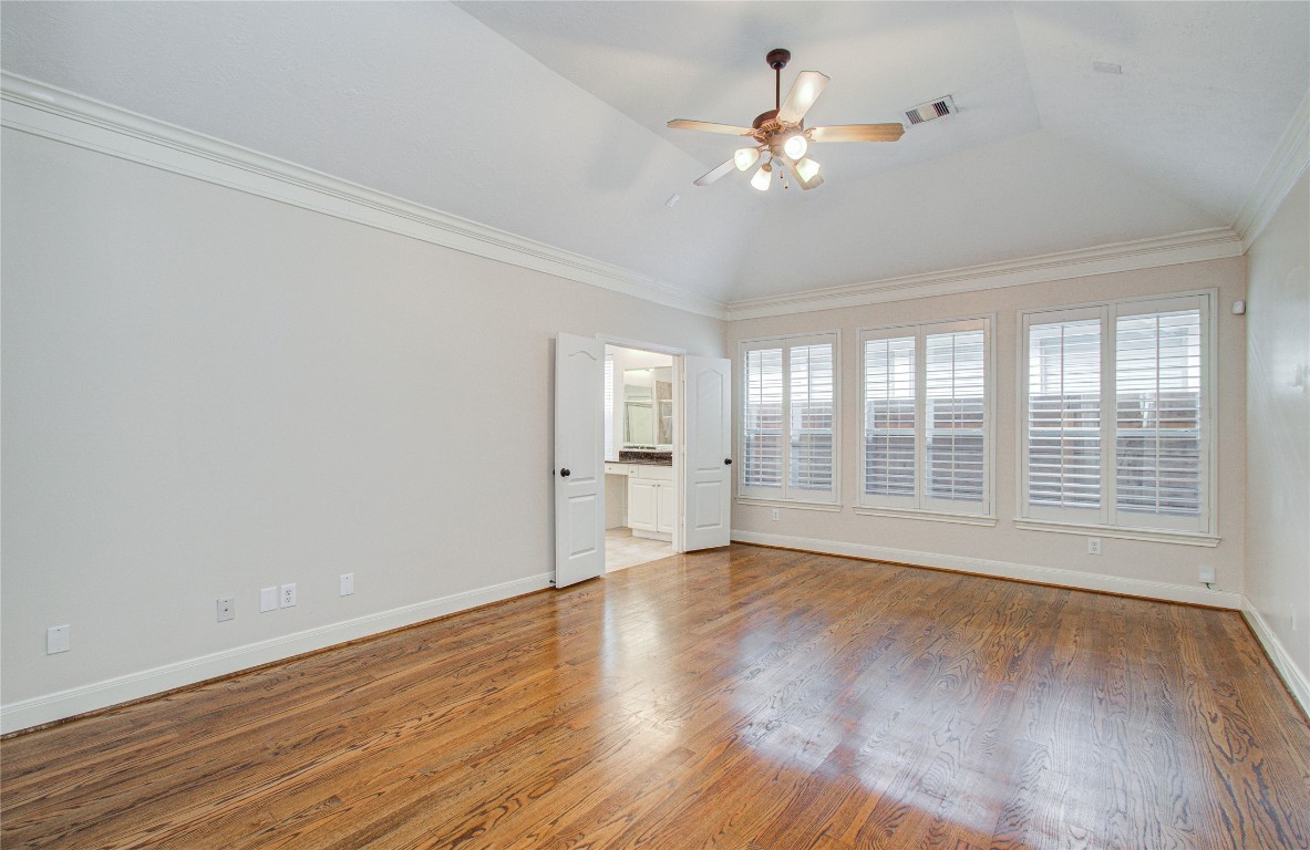 1463 Springrock Lane, Unit A Houston, TX 77055 - Photo 26 of 46 a view of an empty room with a window and wooden floor