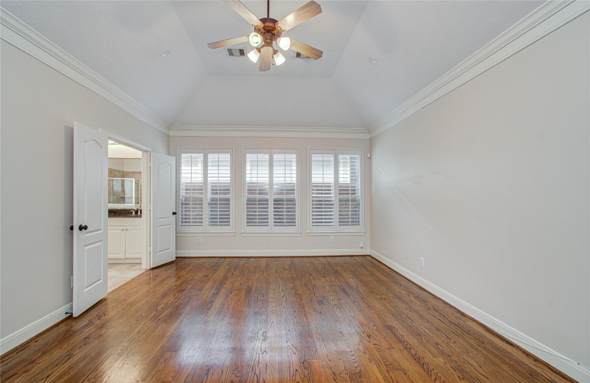1463 Springrock Lane, Unit A Houston, TX 77055 - Photo 27 of 46 a view of empty room with wooden floor and fan