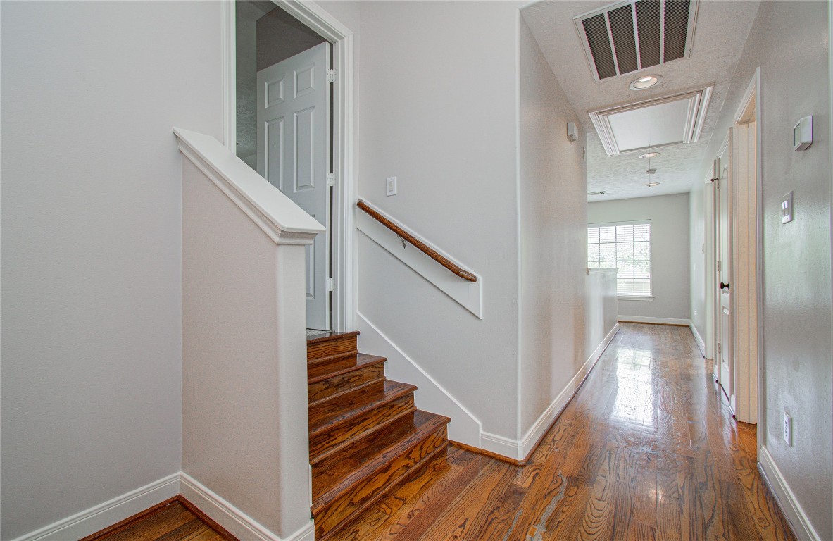 1463 Springrock Lane, Unit A Houston, TX 77055 - Photo 40 of 46 a view of a hallway with wooden floor and entryway