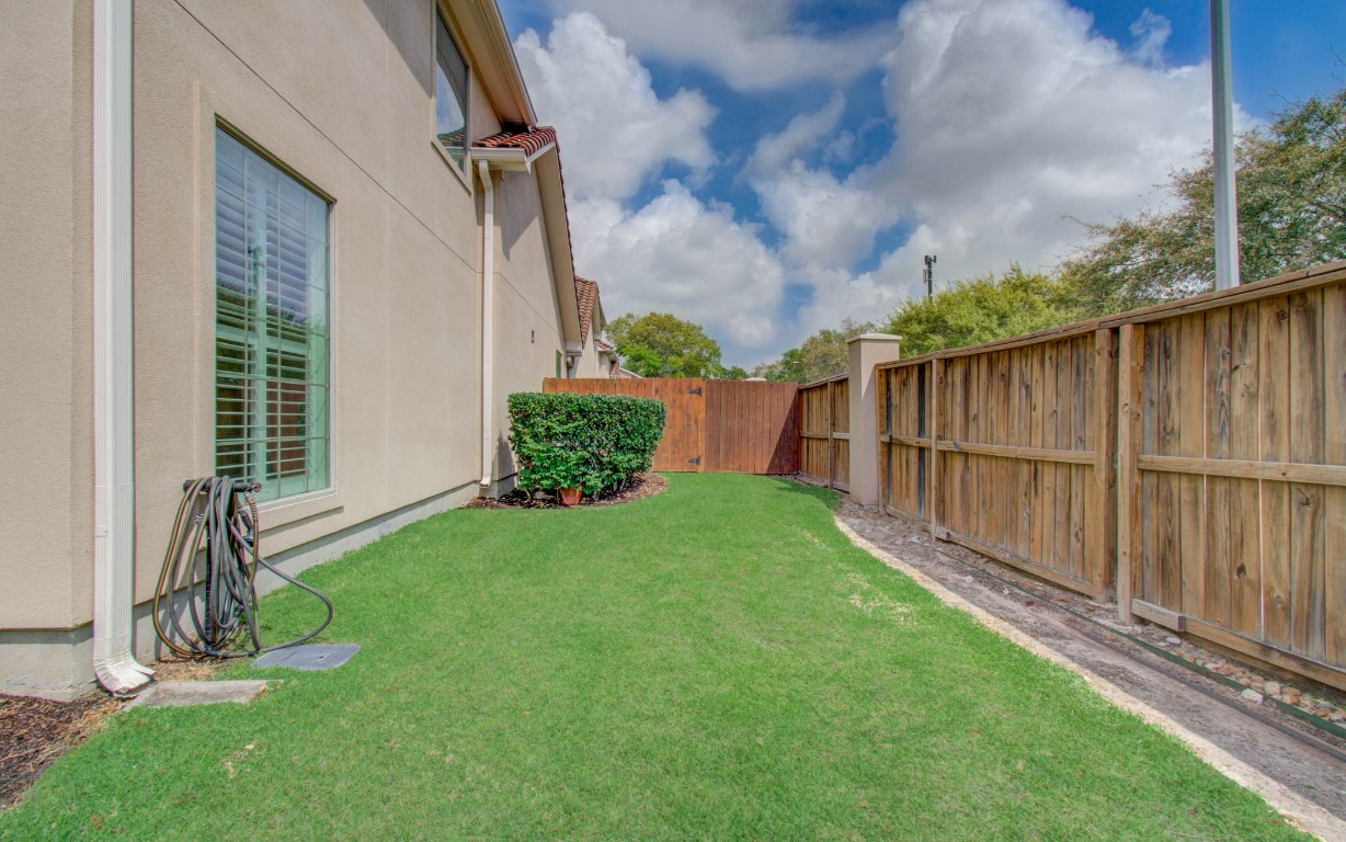 1463 Springrock Lane, Unit A Houston, TX 77055 - Photo 4 of 46 a view of backyard with potted plants wooden floor and fence