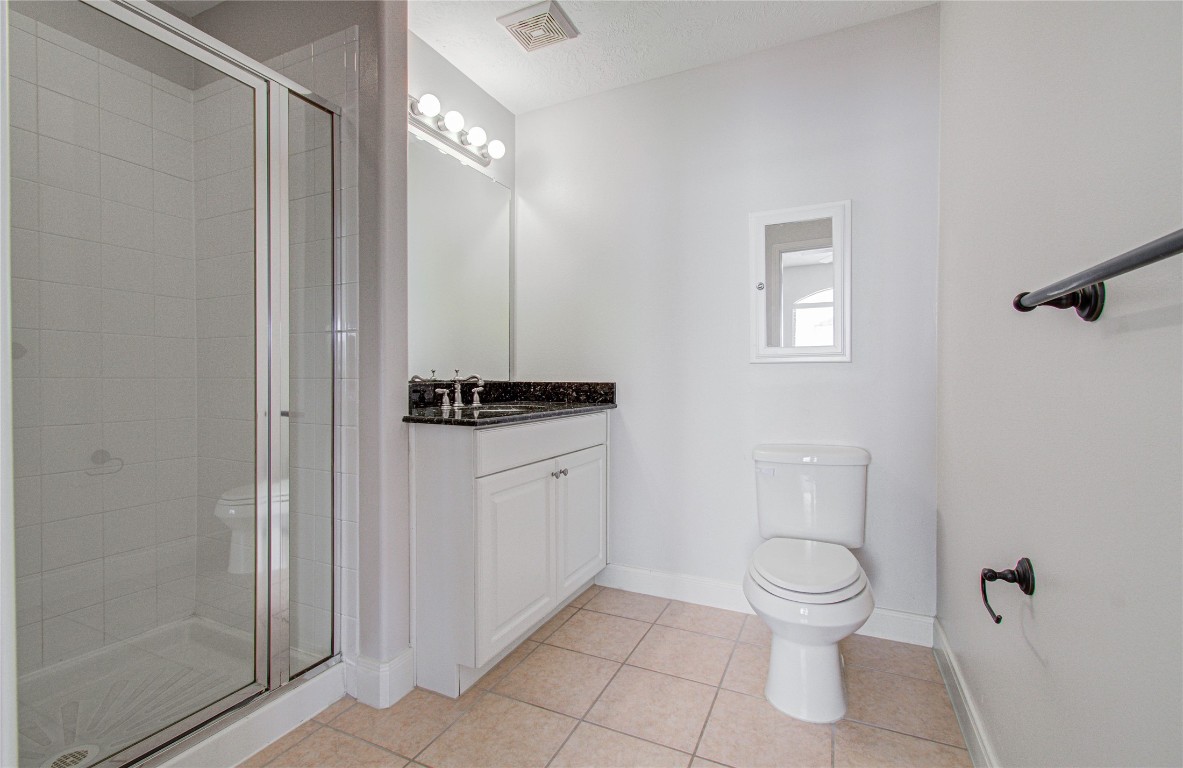 1463 Springrock Lane, Unit A Houston, TX 77055 - Photo 44 of 46 a white toilet sitting next to a bathroom sink