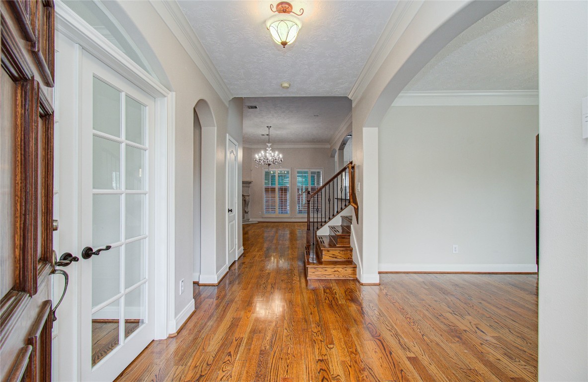 1463 Springrock Lane, Unit A Houston, TX 77055 - Photo 7 of 46 a view of a hallway with wooden floor and staircase