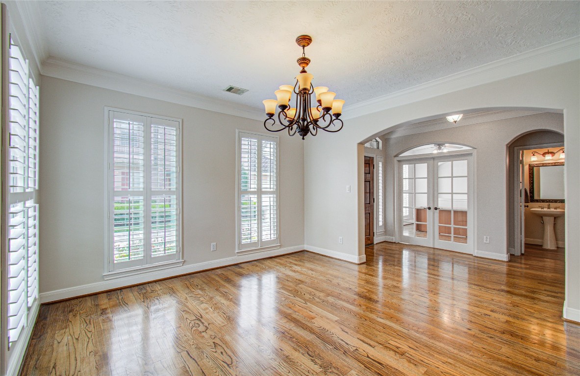 1463 Springrock Lane, Unit A Houston, TX 77055 - Photo 10 of 46 a view of an empty room with wooden floor and a window