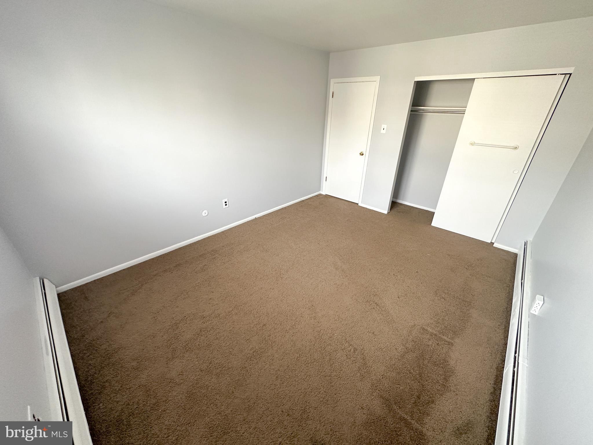 6022 Hegerman Street, Unit 2 Philadelphia, PA 19135 - Photo 7 of 11 an empty room with a wooden floor and closet