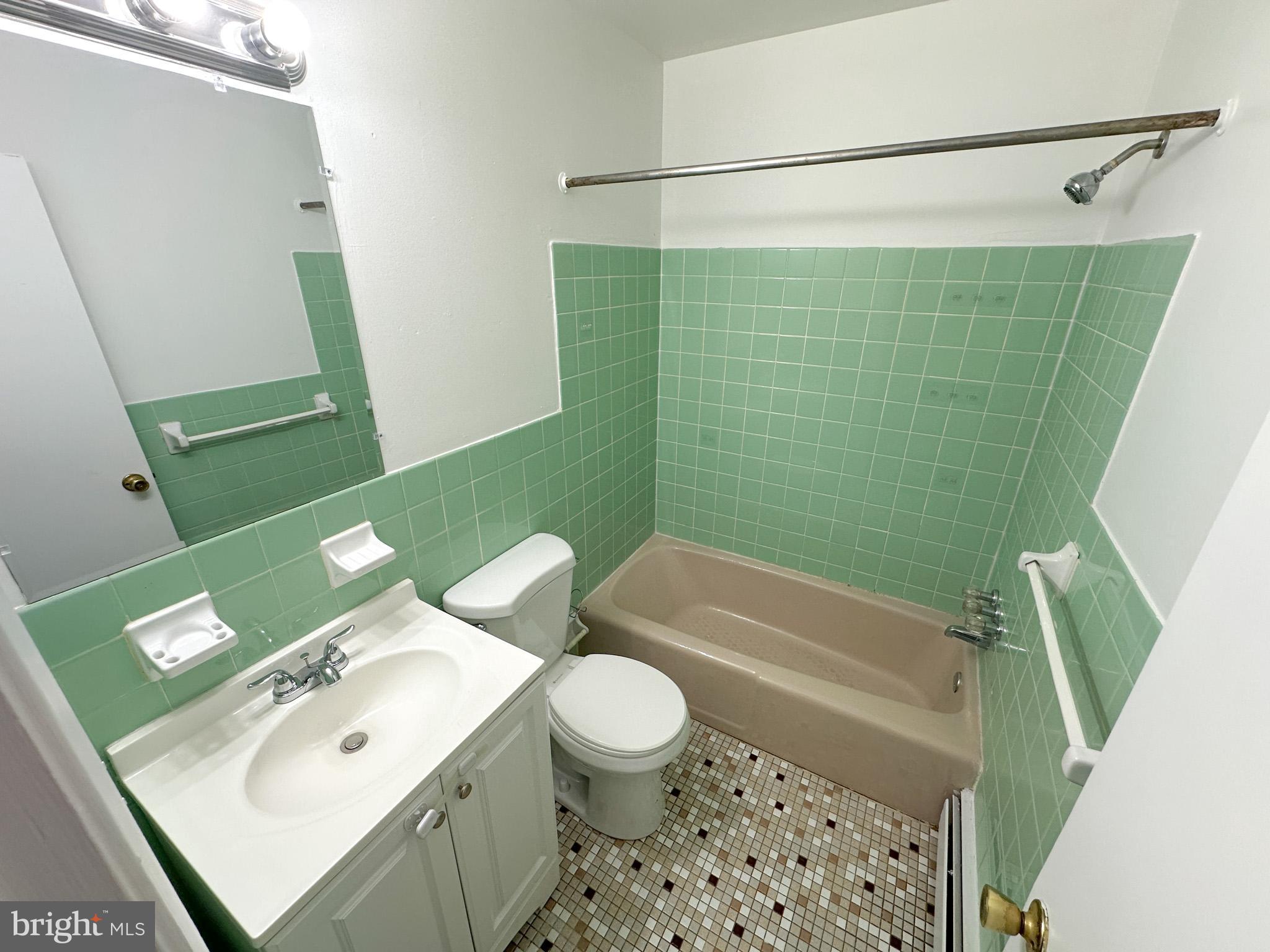 6022 Hegerman Street, Unit 2 Philadelphia, PA 19135 - Photo 8 of 11 a bathroom with a sink a toilet and a bathtub