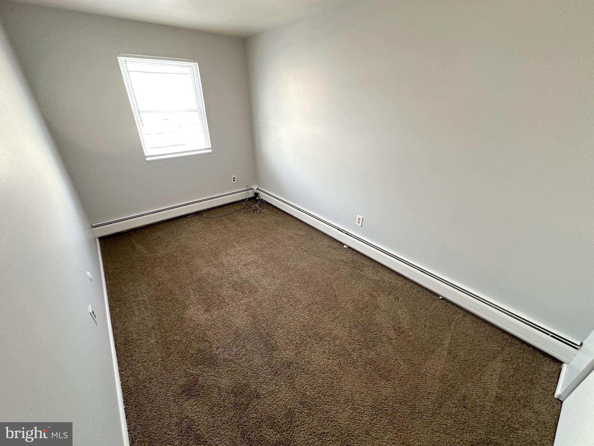 6022 Hegerman Street, Unit 2 Philadelphia, PA 19135 - Photo 10 of 11 an empty room with a window