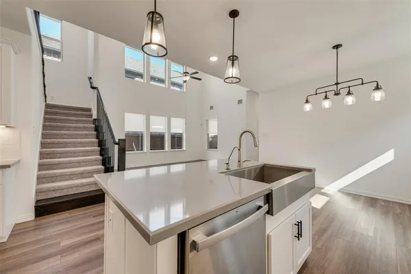 a kitchen with sink and refrigerator
