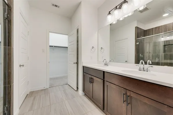 a bathroom with a double vanity sink and mirror
