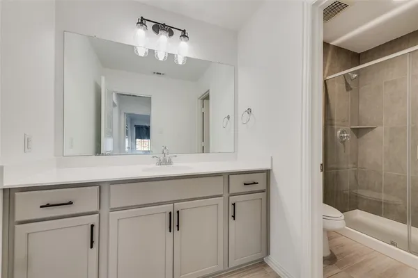 a bathroom with a sink double vanity and shower