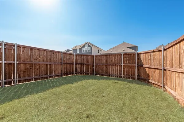 a view of a backyard with a fence