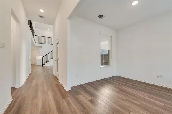 a view of a hallway with wooden floor and entryway