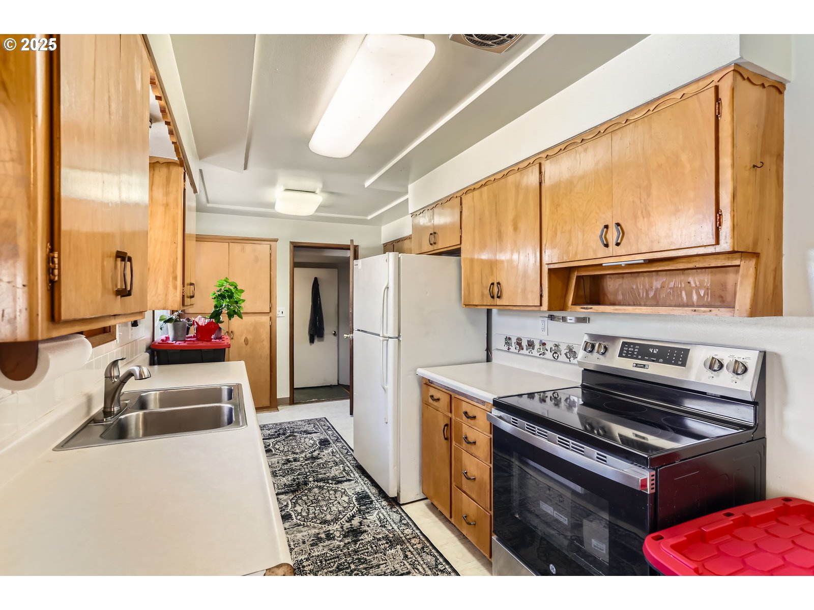14031 Southeast Rhone Street Portland, OR 97236 - Photo 13 of 29 a kitchen with stainless steel appliances granite countertop a stove a refrigerator and a microwave