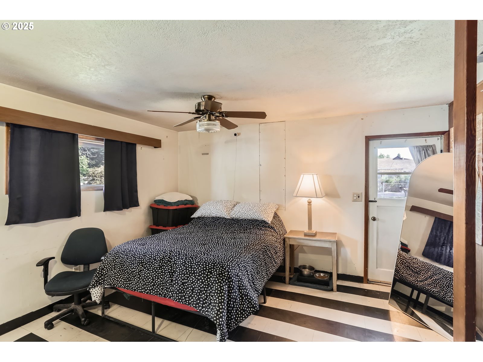 14031 Southeast Rhone Street Portland, OR 97236 - Photo 16 of 29 a bedroom with a bed and wooden floor