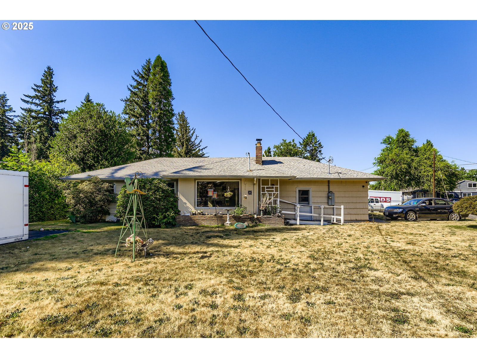 14031 Southeast Rhone Street Portland, OR 97236 - Photo 2 of 29 a backyard of a house with yard and outdoor seating