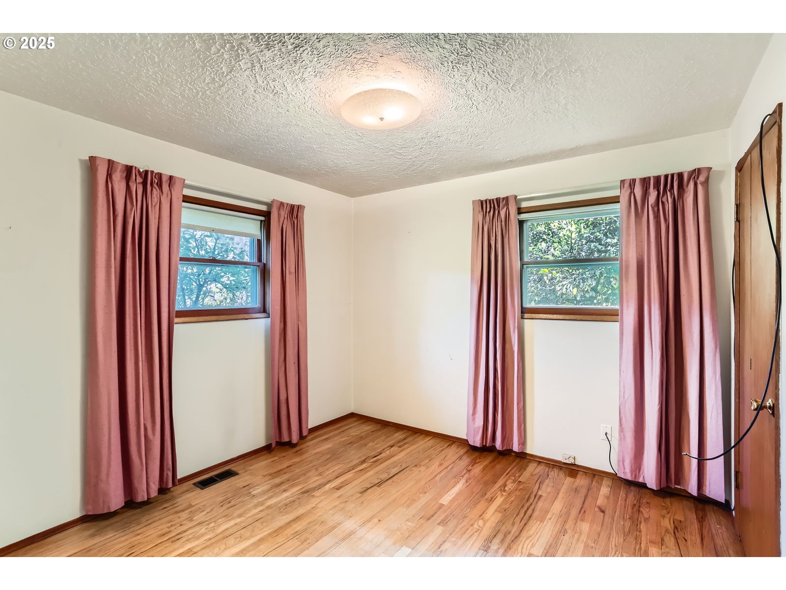 14031 Southeast Rhone Street Portland, OR 97236 - Photo 22 of 29 an empty room with windows and closet