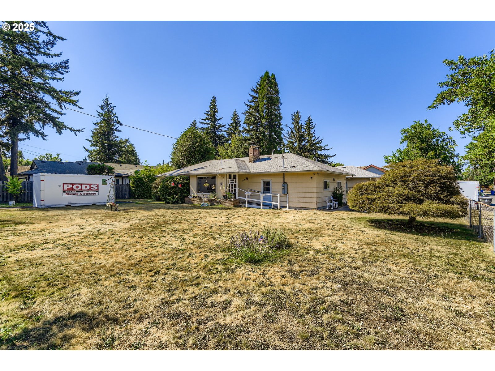 14031 Southeast Rhone Street Portland, OR 97236 - Photo 3 of 29 a front view of a house with a yard