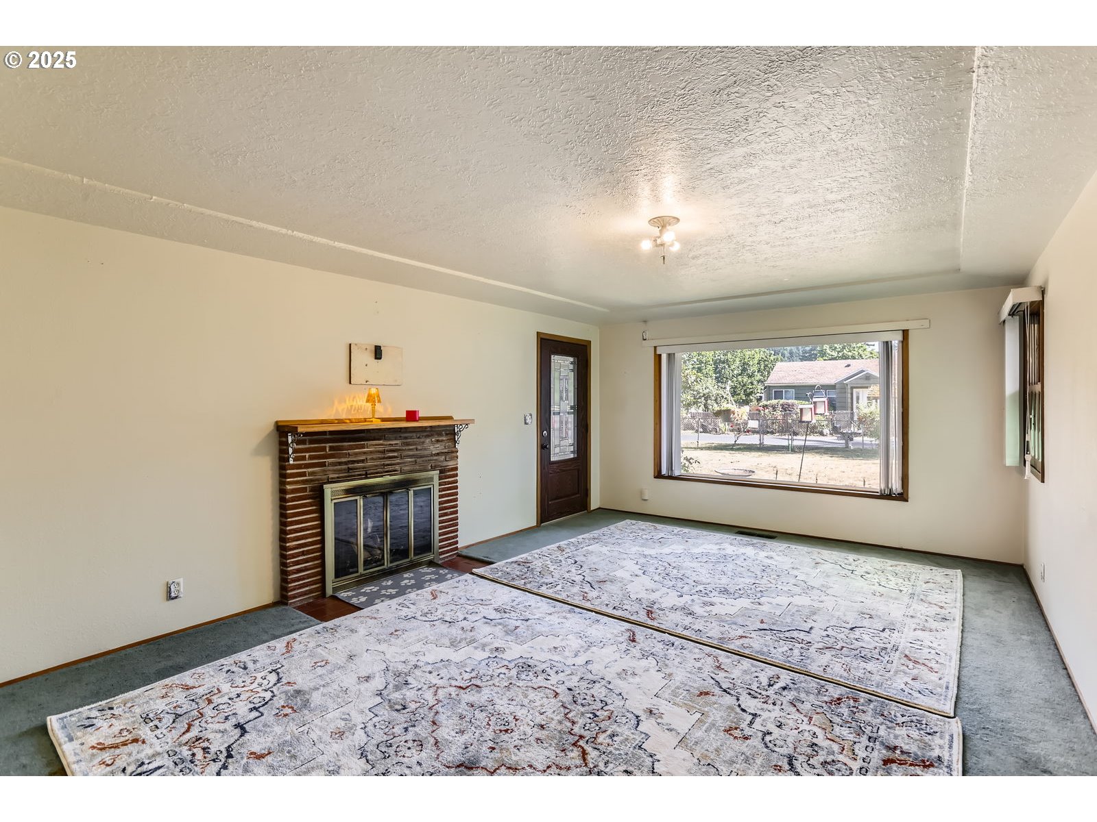 14031 Southeast Rhone Street Portland, OR 97236 - Photo 6 of 29 a view of a hallway with a fireplace and a window