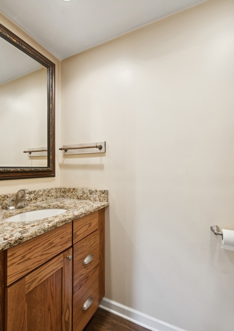 502 Raffel Road Woodstock, IL 60098 - Photo 11 of 24 a bathroom with a granite countertop sink and a mirror