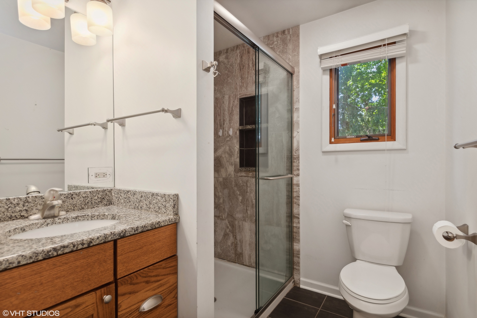 502 Raffel Road Woodstock, IL 60098 - Photo 12 of 24 a bathroom with a granite countertop sink toilet and shower