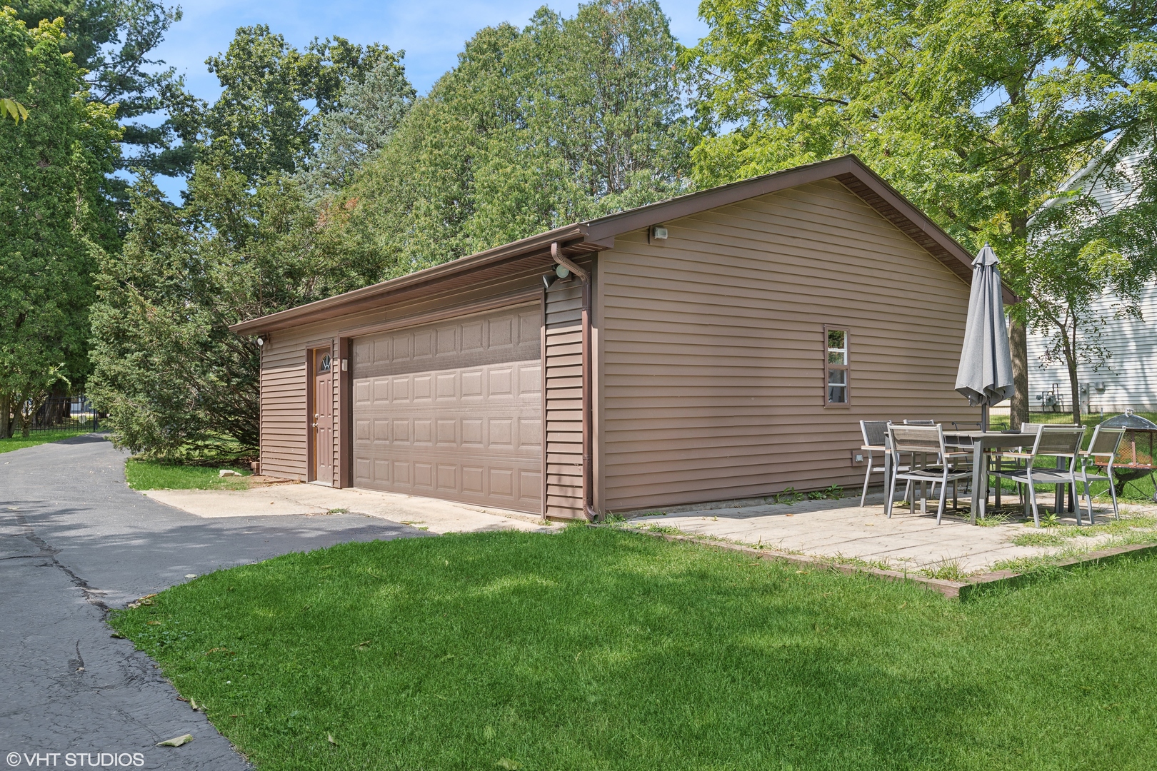 502 Raffel Road Woodstock, IL 60098 - Photo 20 of 24 a backyard of a house with table and chairs