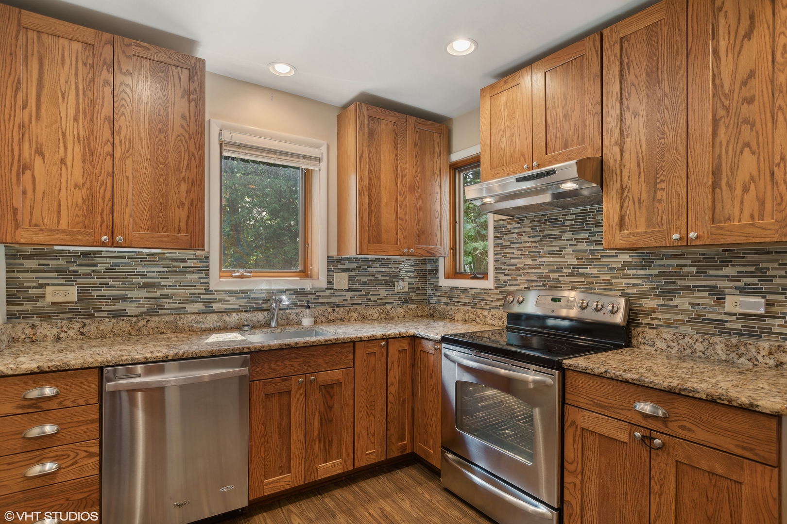502 Raffel Road Woodstock, IL 60098 - Photo 3 of 24 a kitchen with stainless steel appliances granite countertop a sink stove and cabinets