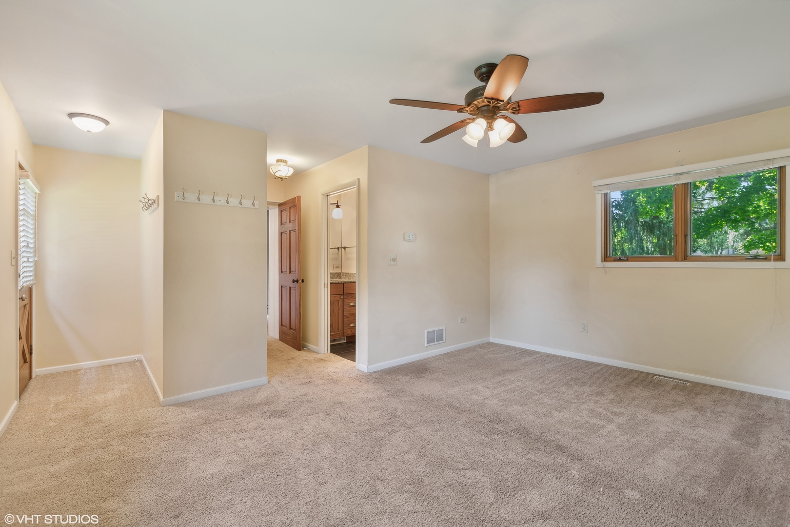 502 Raffel Road Woodstock, IL 60098 - Photo 9 of 24 an empty room with windows and fan