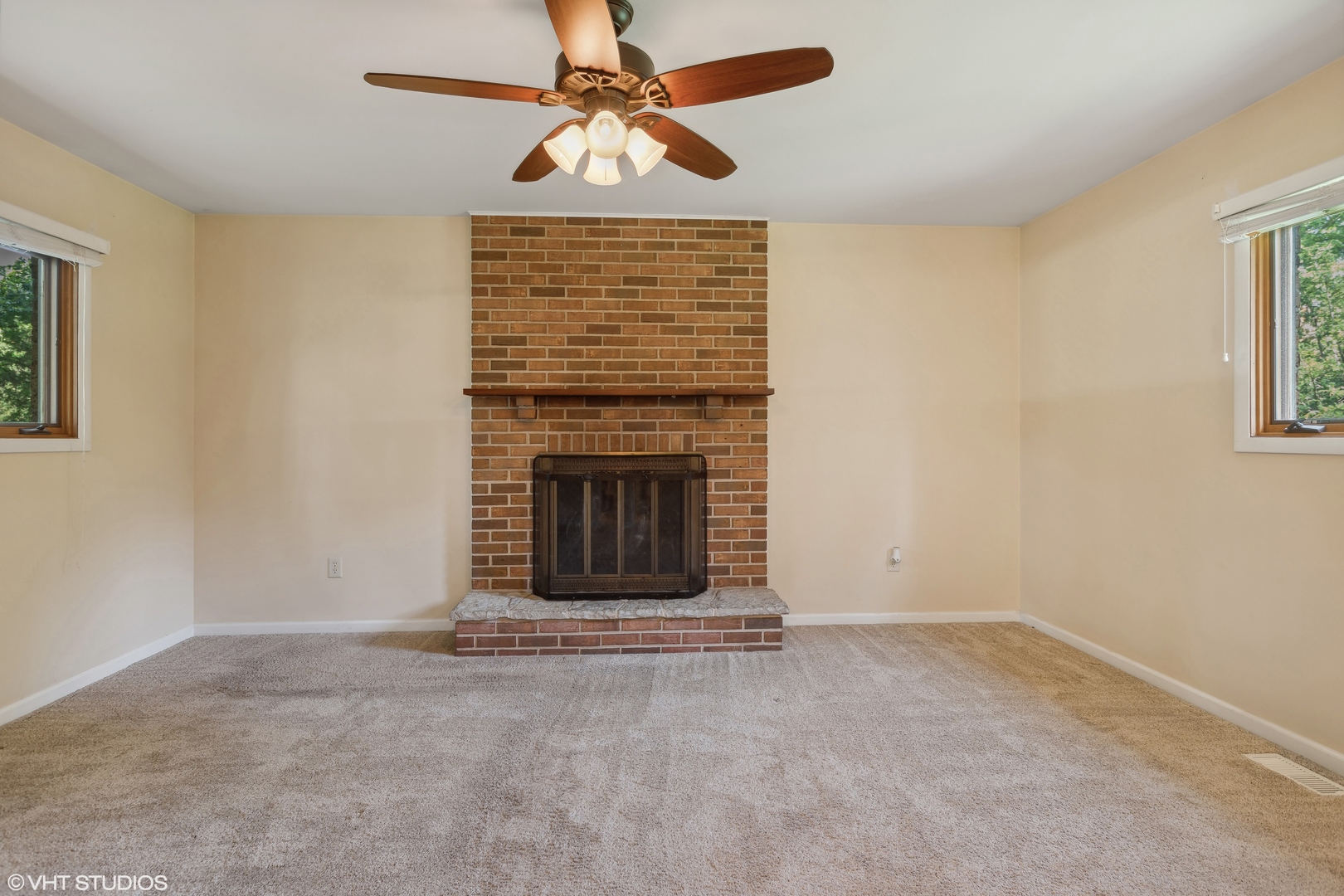 502 Raffel Road Woodstock, IL 60098 - Photo 10 of 24 a view of a livingroom with a fireplace and a chandelier fan