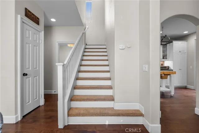 a view of a hallway with wooden floor and entryway