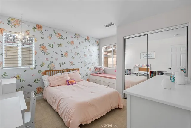 a bedroom with a bed and a large mirror