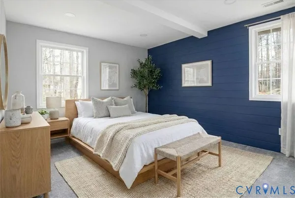 a bedroom with a bed and a potted plant