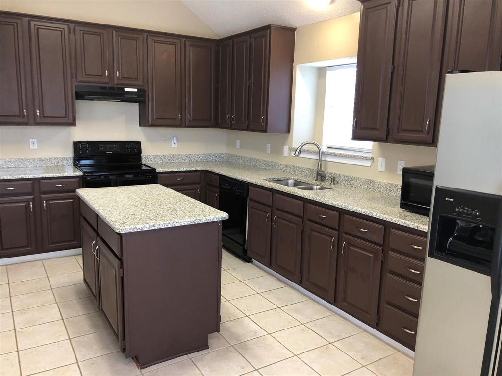 8301 Bells Street Frisco, TX 75035 - Photo 11 of 24 a kitchen with a cabinets and white appliances