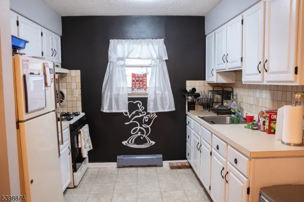 a kitchen with a refrigerator a stove and a refrigerator