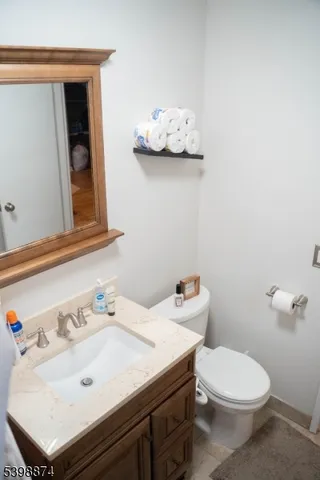 a bathroom with a sink mirror and toilet