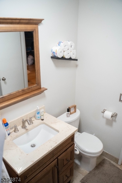 37 Espy Road, Unit 6B Caldwell, NJ 07006 - Photo 13 of 20 a bathroom with a sink mirror and toilet