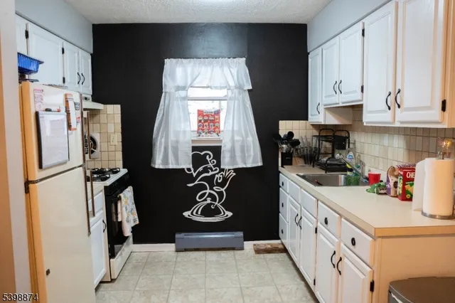 a kitchen with a refrigerator a stove and a refrigerator