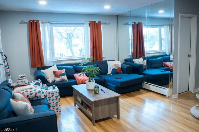 a living room with furniture and wooden floor