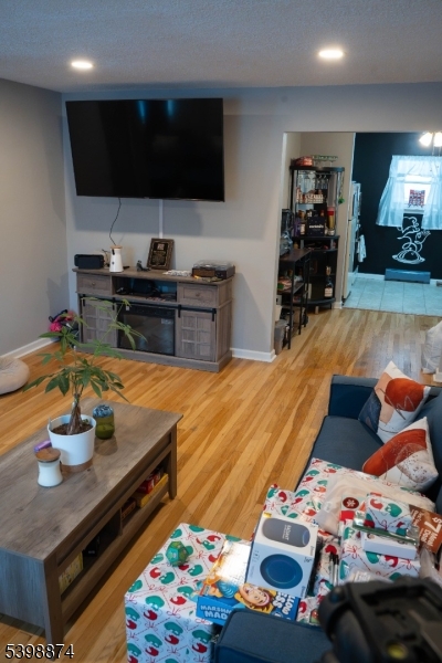 37 Espy Road, Unit 6B Caldwell, NJ 07006 - Photo 5 of 20 a living room with furniture and a flat screen tv