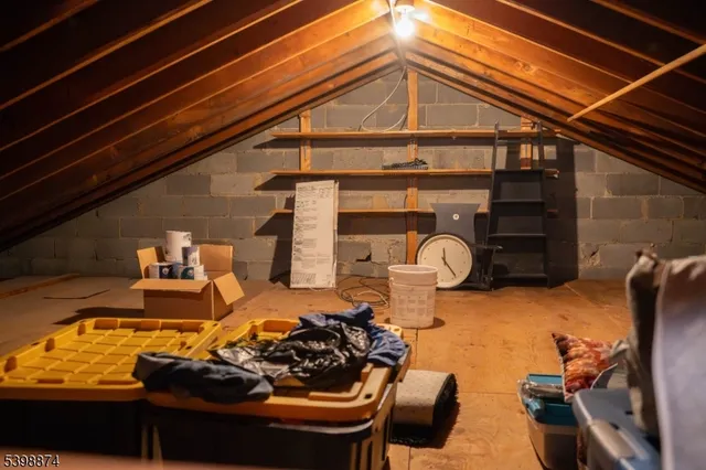 a view of a roof deck with chair and potted plants