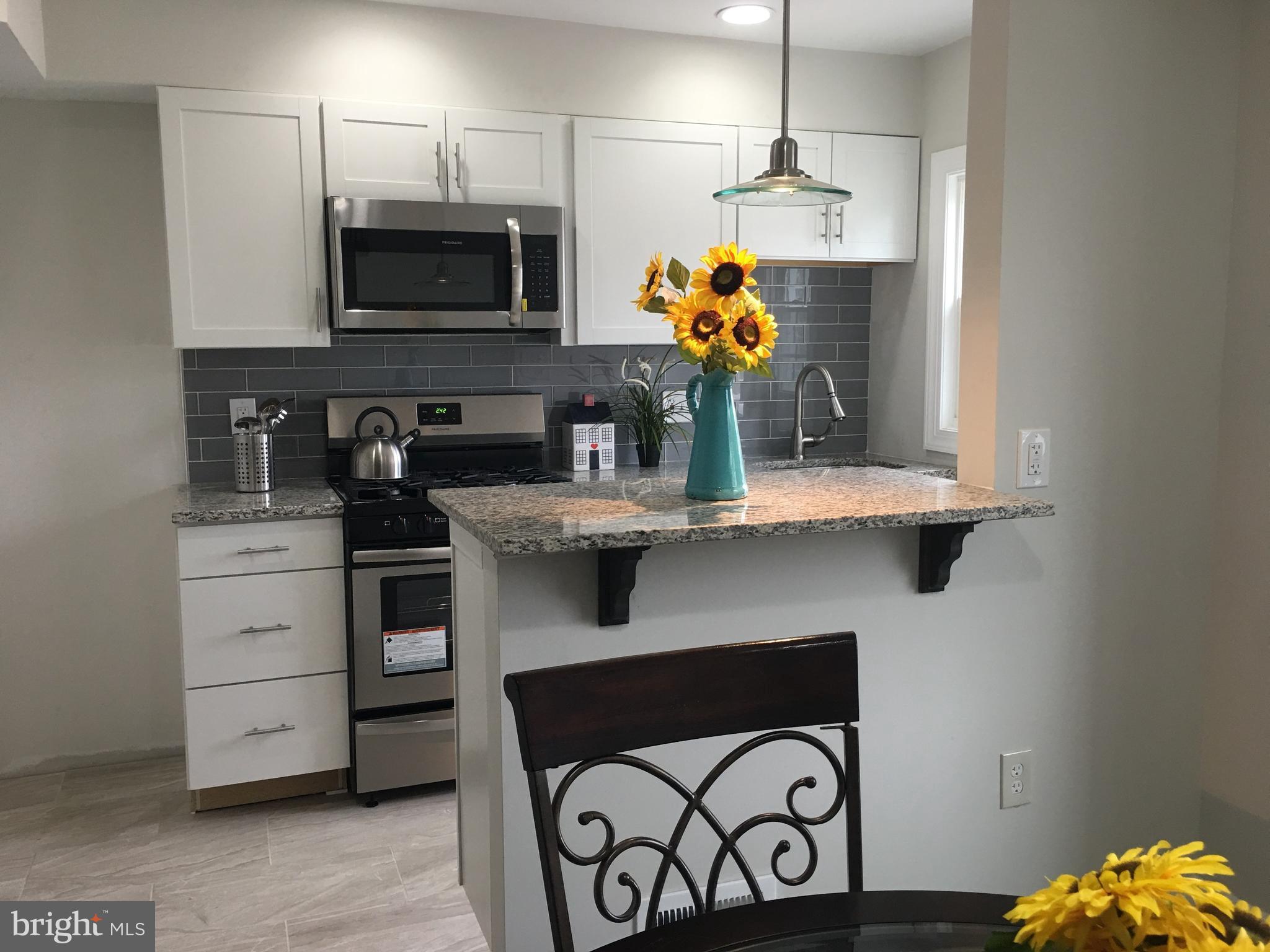 7968 Kavanagh Road Baltimore, MD 21222 - Photo 15 of 30 a kitchen with a refrigerator and a stove