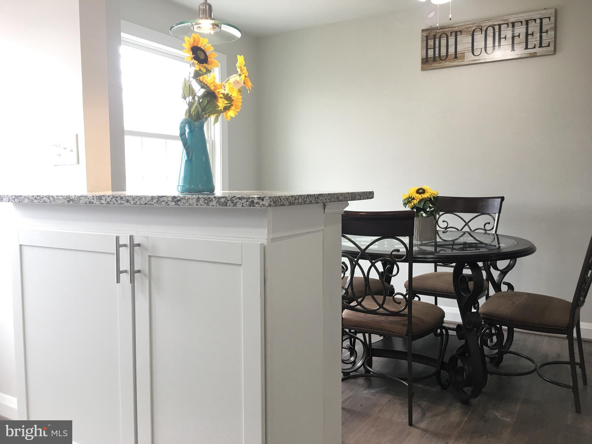 7968 Kavanagh Road Baltimore, MD 21222 - Photo 18 of 30 a view of a dining room with furniture and chandelier