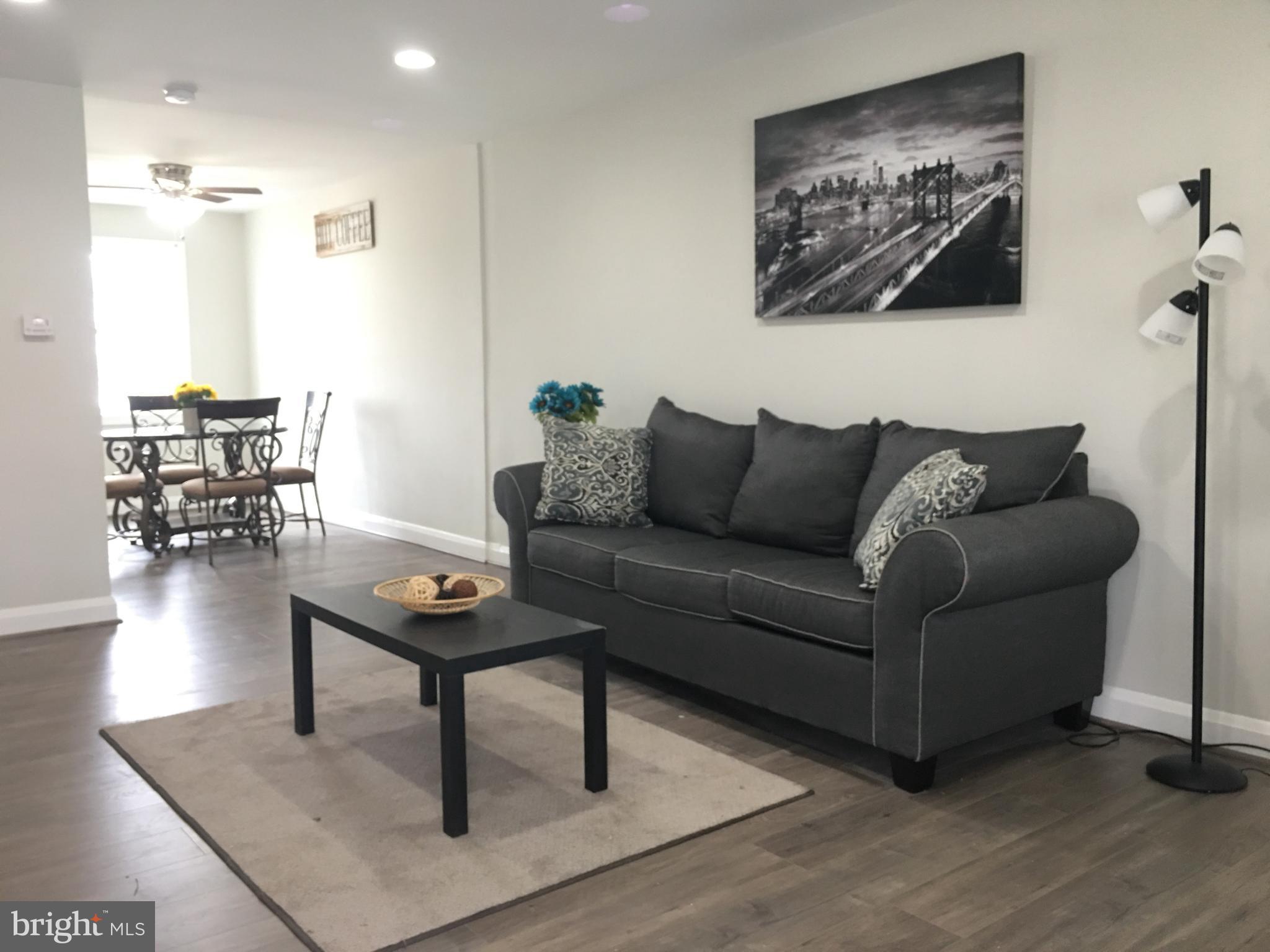 7968 Kavanagh Road Baltimore, MD 21222 - Photo 3 of 30 a living room with furniture and a wooden floor