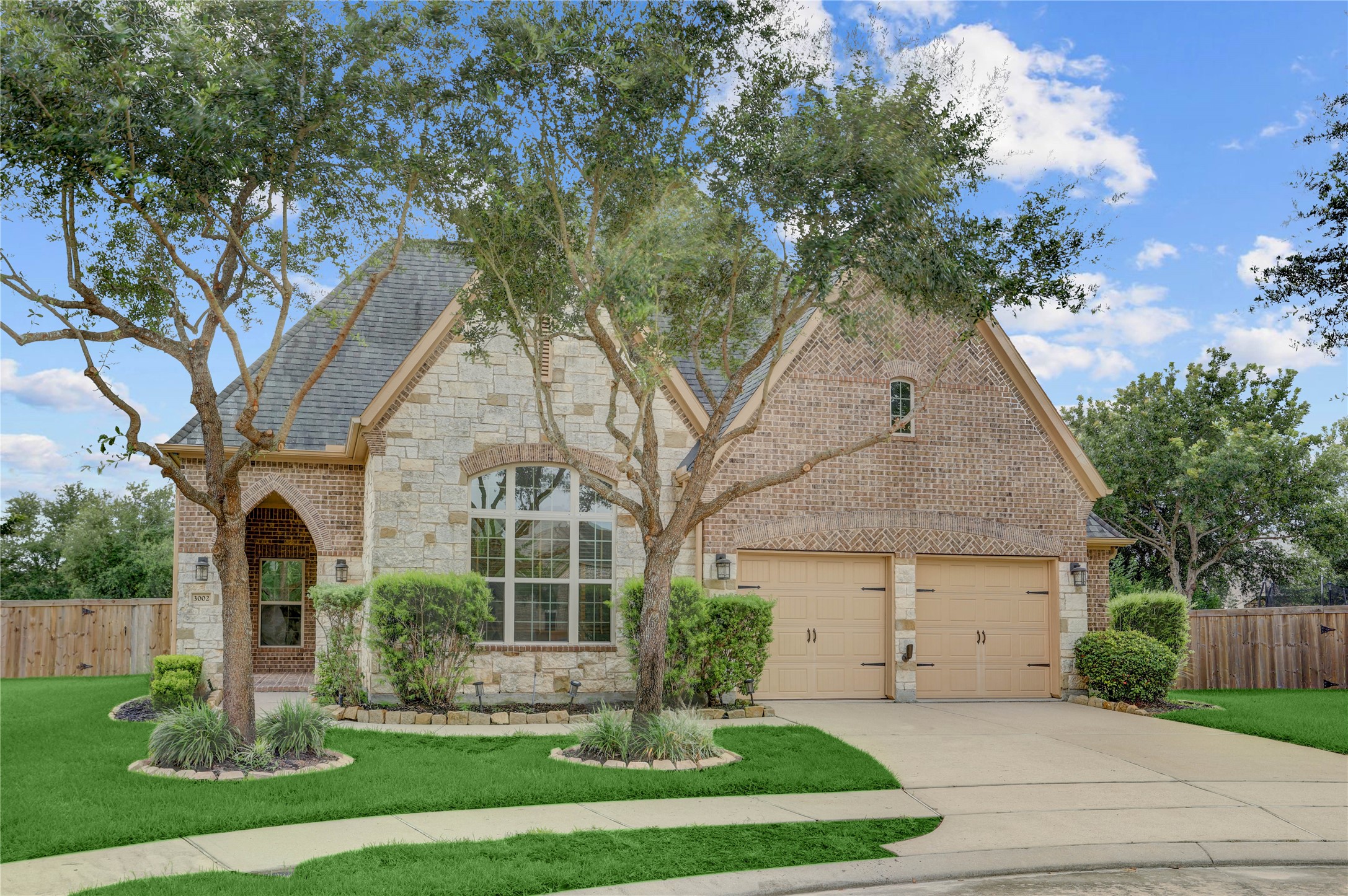 3002 Currant Drive Manvel, TX 77578 - Photo 2 of 43 a front view of a house with a yard and potted plants