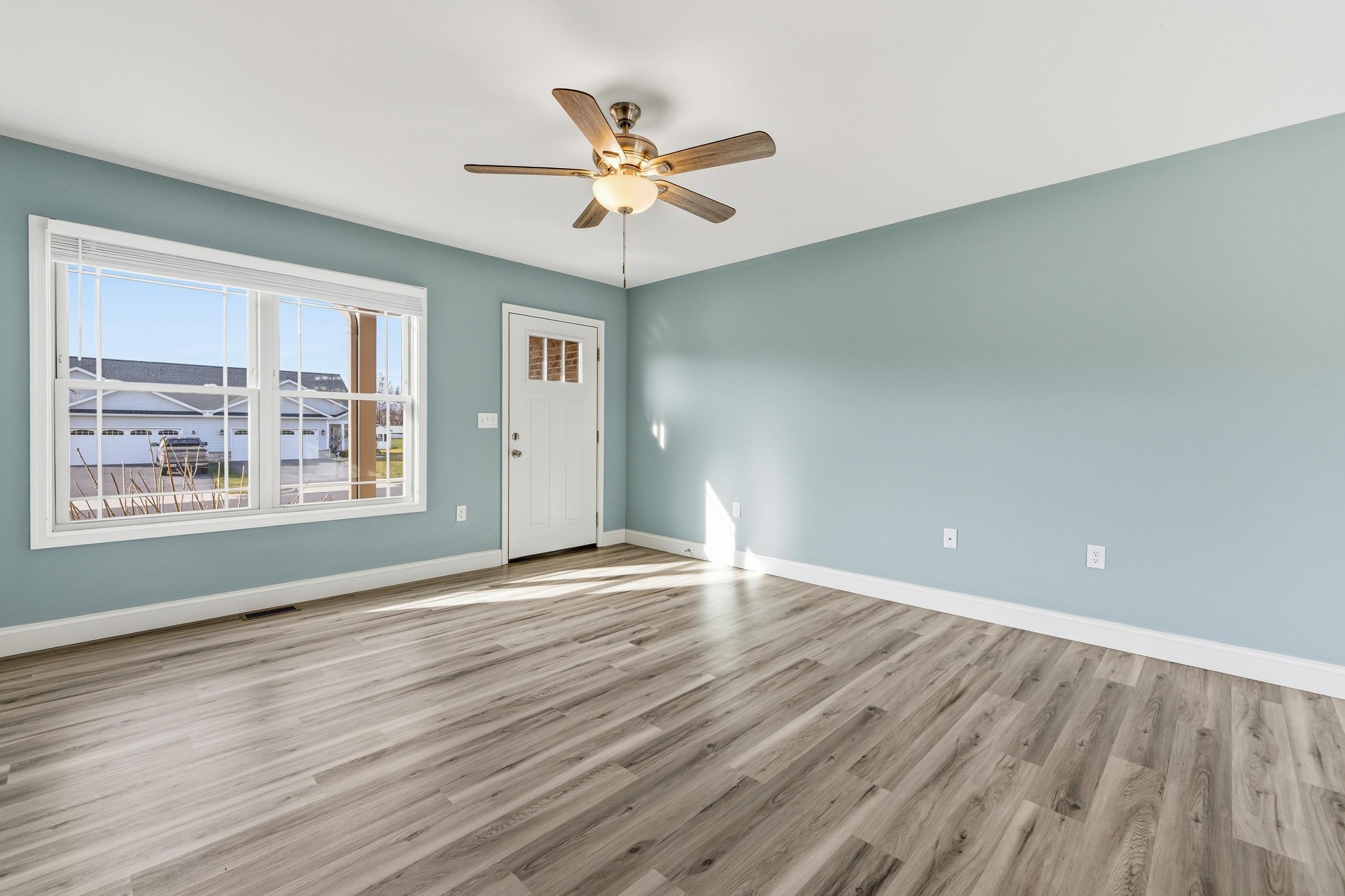 136 Millstone Street Bridgewater, VA 22812 - Photo 17 of 75 an empty room with wooden floor chandelier fan and windows