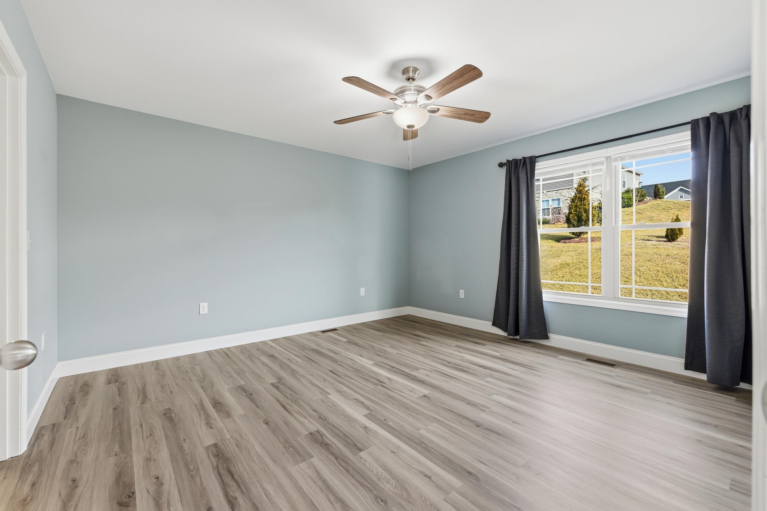 136 Millstone Street Bridgewater, VA 22812 - Photo 22 of 75 a view of an empty room with wooden floor and a window