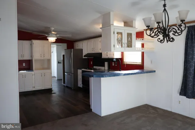 a kitchen view with microwave a stove and refrigerator