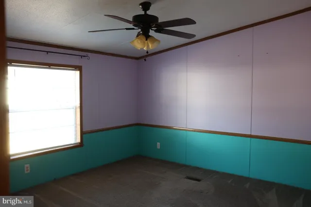 a room with a window and a fan